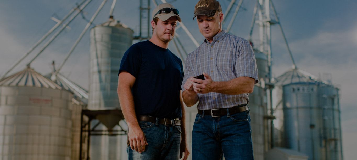 Two men looking at Tablet Using Valley Irrigation Services
